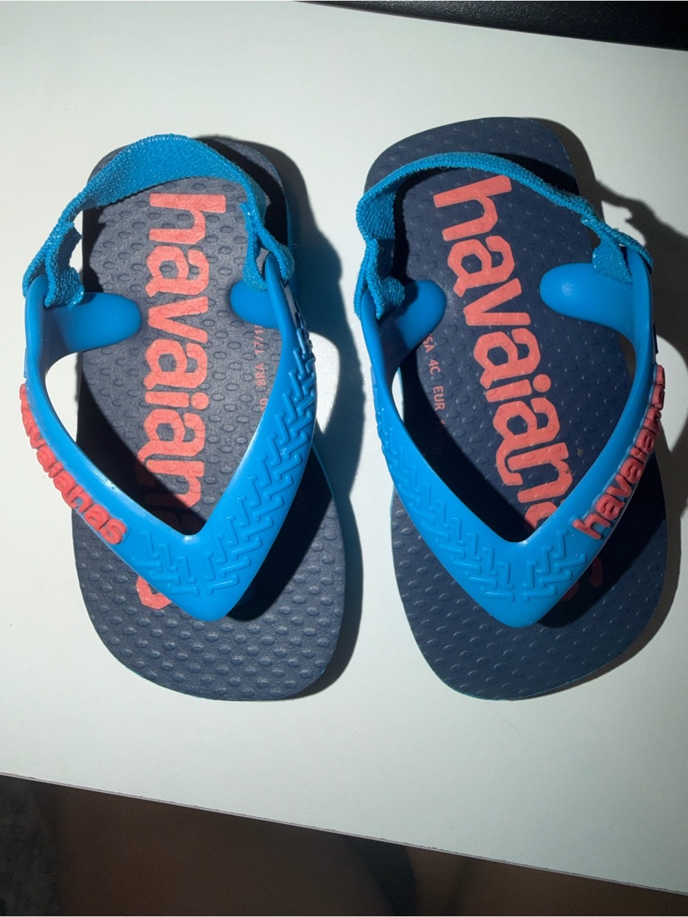 Havaianas Kids Bright Blue Strap Navy Footbed Flip Flops with Coral Logo